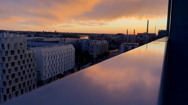 Dramatic Sunset over J&auml;tk&auml;saari Rooftops from an Urban Nordic Balcony View