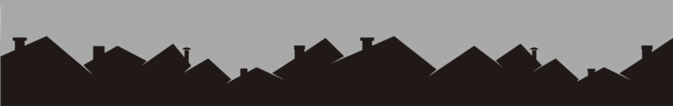 Black silhouette of house rooftops against a gray sky, urban housing