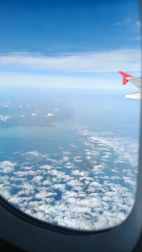 View from Airplane Window Above the Clouds