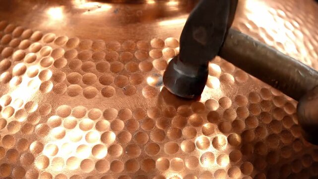 Hand hammering copper plate with dimples, metalwork process