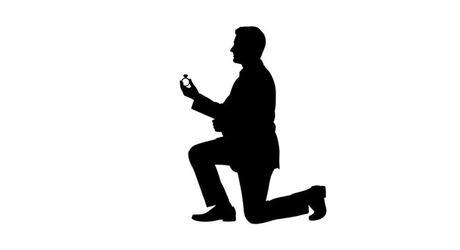 Man kneeling proposing with ring silhouette.