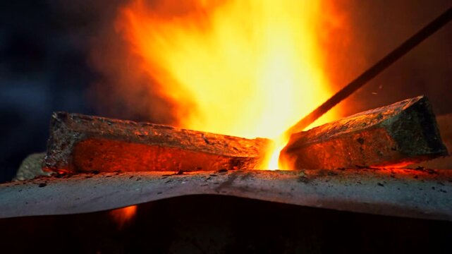 Glowing Metal Ingots in Blazing Furnace at Foundry