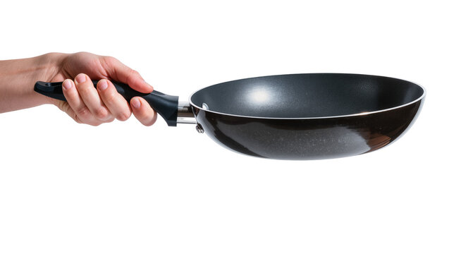 Hand holding black frying pan with metal rim