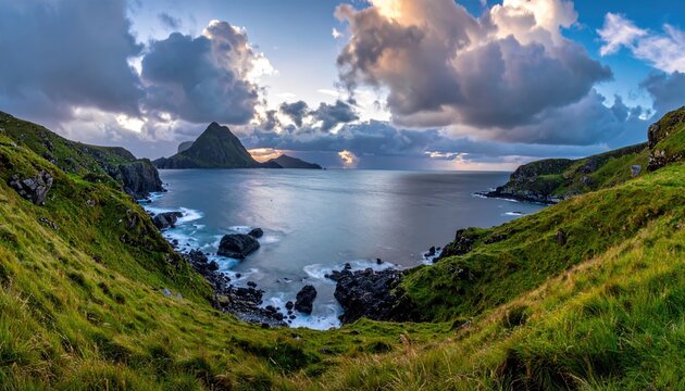 Dramatic coastal vista at sunset with rugged cliffs and distant misty mountains