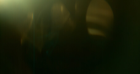 Naklejka premium Abstract cinematic lens flare with soft bokeh circles and subtle light reflections. Atmospheric optical effect background ideal for overlays, visual effects, film production and creative design.