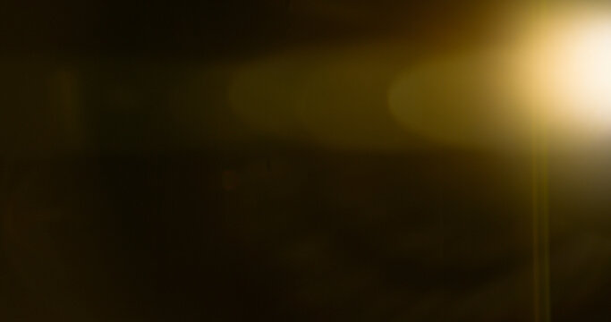Anamorphic lens flare and light leak effect on dark background. Minimal cinematic optical texture ideal for overlays, film production, motion graphics and visual effects.