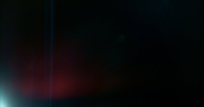 Anamorphic lens flare and light leak effect on dark background. Minimal cinematic optical texture ideal for overlays, film production, motion graphics and visual effects.