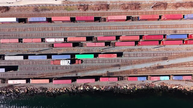 Glimpse the lively railway yard in Halifax, Canada, where colorful cargo containers stand in rows, ready for shipping and transport every morning