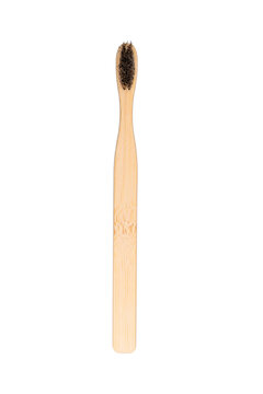 Bamboo toothbrush with dark bristles isolated on white background