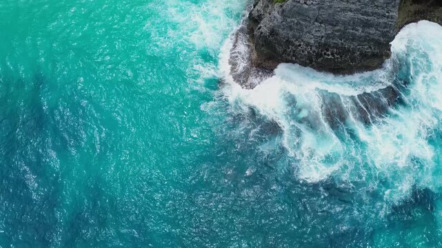 Aerial drone view of tropical sea stack and turquoise ocean in Nusa Penida Bali Indonesia