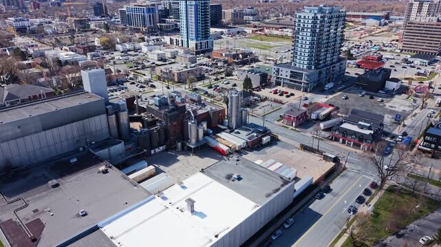 Experience the stunning aerial view of Labatt Brewing Co in Nova Scotia. This captivating visual reveals the bustling brewery and surrounding urban scenery