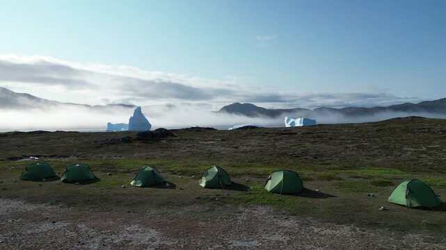 Aerial view of remote expedition camp with icebergs in South Greenland