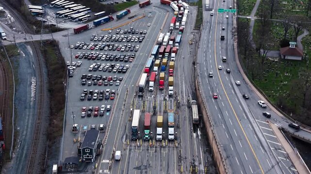 Aerial perspective reveals a long queue of semi-trailer trucks at Port of Halifax, highlighting the vibrant activity in this key transportation hub of Nova Scotia, Canada