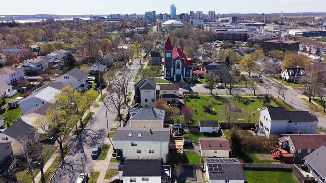 Majestic aerial shots showcase the historic St. Stephen Church in Halifax, surrounded by lush greenery and charming homes, highlighting the city's spring charm and vibrant life