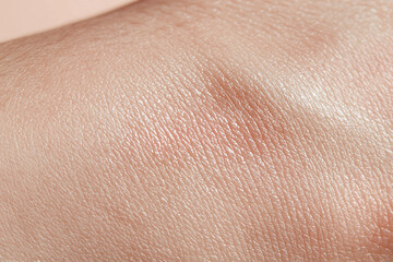 Fototapeta premium Hydrated skin closeup, smooth glowing surface, natural texture and fine lines visible, soft neutral tone and healthy sheen conveying gentle care and skin wellness