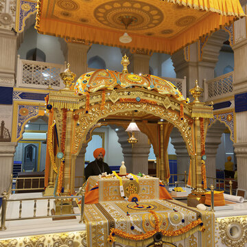Interior View of a Sikh Gurdwara with Ornate Palki Sahib