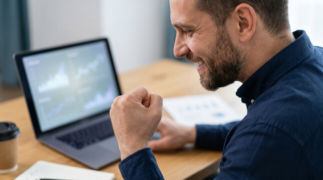 Successful Businessman Fisting Pump Celebrating Stock Profit Growth on Laptop