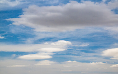 Fototapeta premium Multiple Lenticular Cloud Formations Suspended Across a Blue Sky