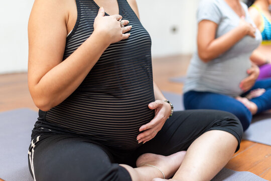 Pregnant women practicing prenatal yoga