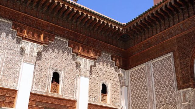 pan up of the details of the exquisite decorated facade in the Patio / Central Courtyard in Madrasa Ben Youssef, Morocco travel 