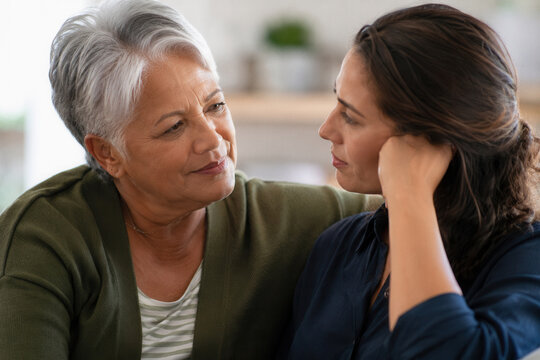 Two women share a gentle, intimate moment