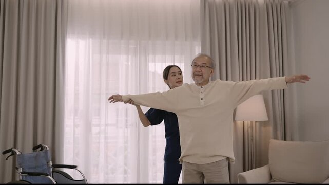 Professional beautiful Asian woman nurse physiotherapist helping senior man stretch arm and back for physiotherapy and rehabilitation of orthopedic conditions at hospital. Healthcare older concept. 