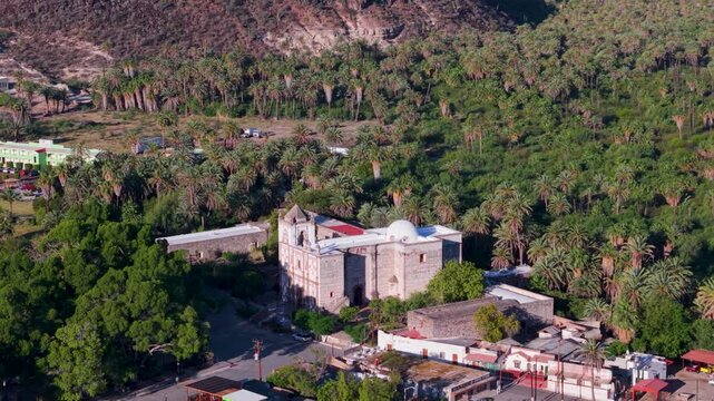 Experience aerial views of the Mission Church in San Ignacio, Baja California. Discover the rich landscape and historic site.