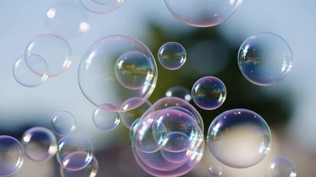 Colorful soap bubbles floating in the air against a blurred background. Represents joy, playfulness, and the essence of childhood fun