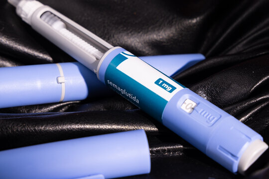 Semaglutide glp1 weight loss injection devices displayed on dark black leather pants for type 2 diabetes control and lifestyle.