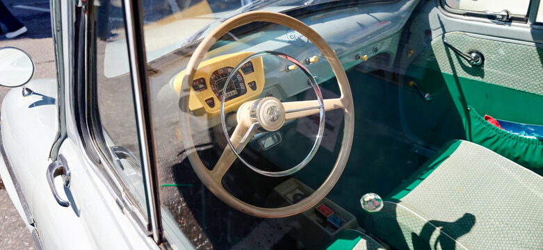 Saint Petersburg, Russia - May 23, 2026: ZAZ Zaporozhets vintage car interior featuring wooden steering wheel, green upholstery, and dashboard controls in a classic design