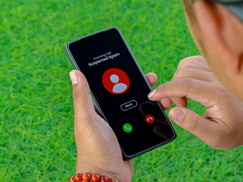 Close Up Person Receiving Incoming Call on Smartphone in Green Grass