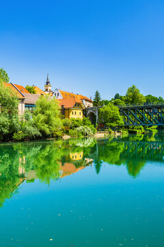 Skyline of town of Novo Mesto, mirrored in Krka river, Slovenia
