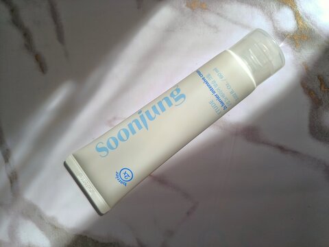 Etude house soonjung 2x intensive barrier cream, face moisturizer, popular viral korean skincare product, top view tube Isolated on light marble background in sunlight 