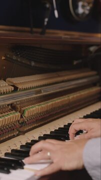 Upright Piano Close-Up &mdash; Hammers, Hands and Electric Guitars in Bokeh
