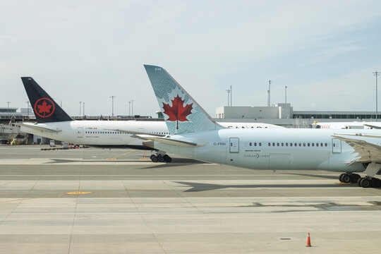 Richmond, BC, Canada - June 13, 2023: A Boeing 787-9 Dreamliner and a Boeing 777-200 aircraft operated by Air Canada are seen at Vancouver International Airport in Richmond, British Columbia.