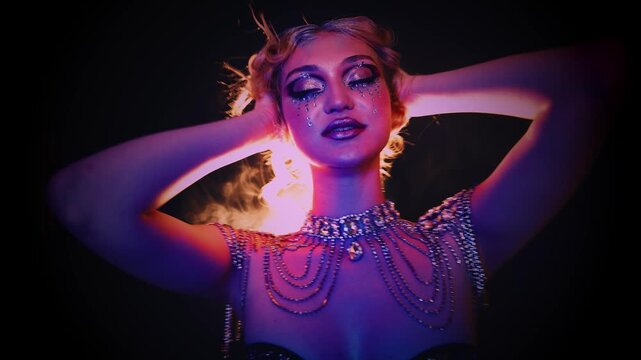 Portrait happy smiling face fashion model enjoy music dancing waving body head, woman shiny art make up rhinestones glitter dress. blue pink purple neon light teen girl in slow motion close-up hands