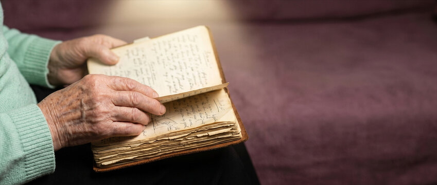 Elderly Hands Reading Old Diary Memory and Alzheimer Concept