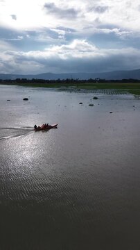 Fast Moving Fishing Boat on Rawa Pening Lake with Mountain Scenery Aerial Drone View