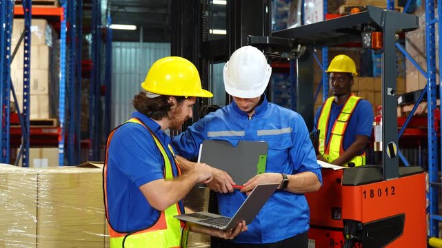 Worker discuss in warehouse using laptop in conversation. Safety inspection,Training employee for logistic employee in warehouse. Digital technology, Team meeting and supply chain with manager for hel
