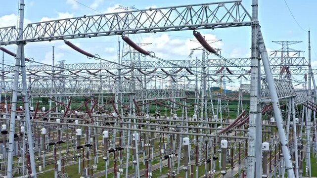 High Voltage Electrical Substation and Transmission Towers Under Blue Sky