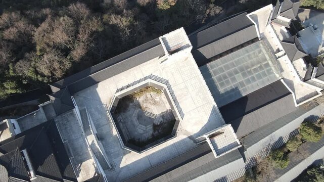 Aerial Top View of Modern Building with Octagonal Courtyard and Trees