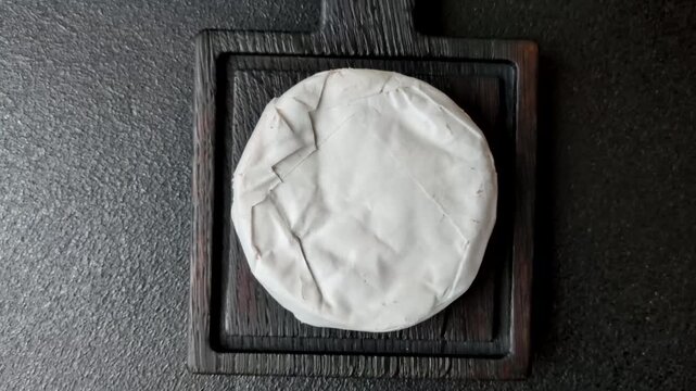Pink Brie or Camembert cheese with honey, jam, figs, and crackers for a hearty breakfast. Brie cheese as a food background for your design