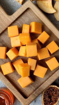 Hard yellow cheddar cheese for sandwiches or pasta. Cheddar cheese as a food background for your design
