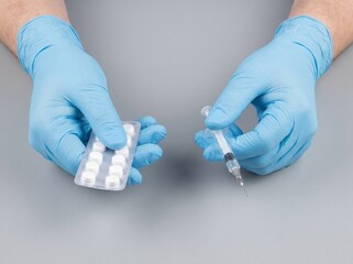 Obraz premium Hands offering a needle or pills