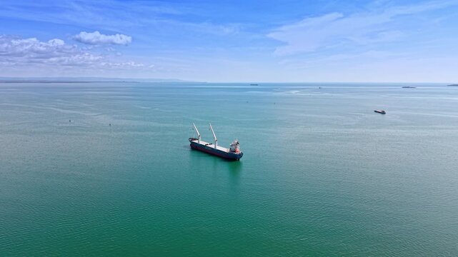 Beautiful vast waterscape with some ships on. Cargo vessels on the roadstead. Aerial view.