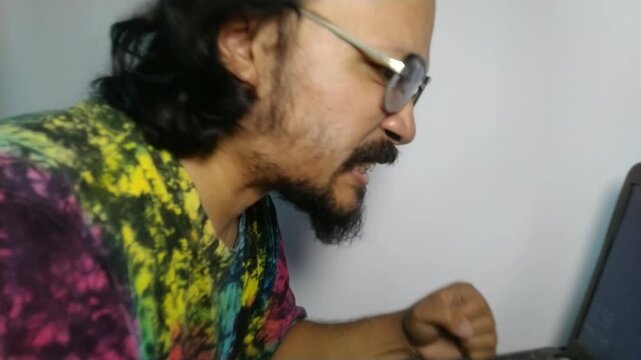 Frustrated Gamer Reacting to Losing a Match on Laptop.