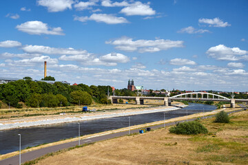 Fototapeta premium Cityscape with a road bridge over the Warta River and the towers of the historic cathedral in Poznan