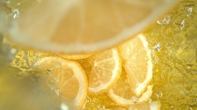 Super Slow Motion Shot of Fresh Lemon Slices Falling into Lemonade at 1000fps.