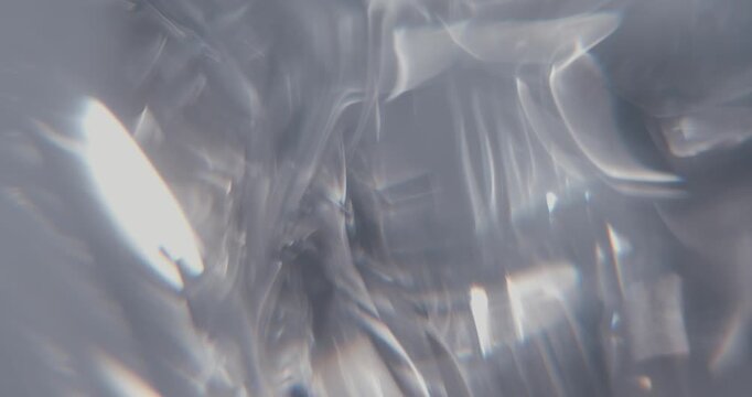 Abstract gray background with moving lens flares and refractions. Delicate colors bokeh effect for luxury logo display. Grey-blue light leaks on a blurred background with copy space. 