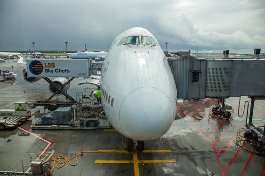 ground handling of a jumbo jet B747 by rain at Frankfurt international airport.